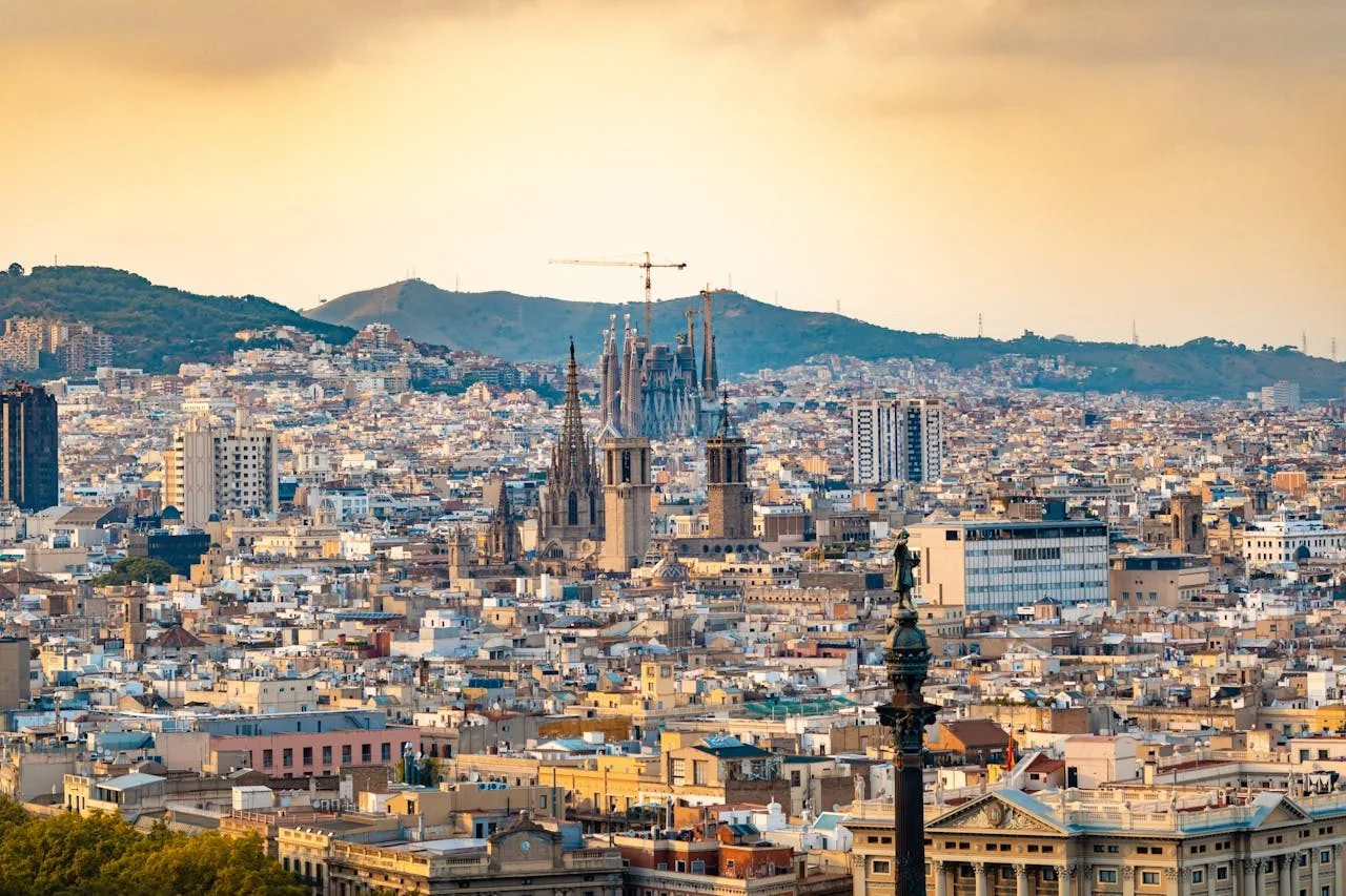 Vista de Barcelona al capvespre, amb les torres de la Sagrada Família retallades sobre els terrats de l'Eixample